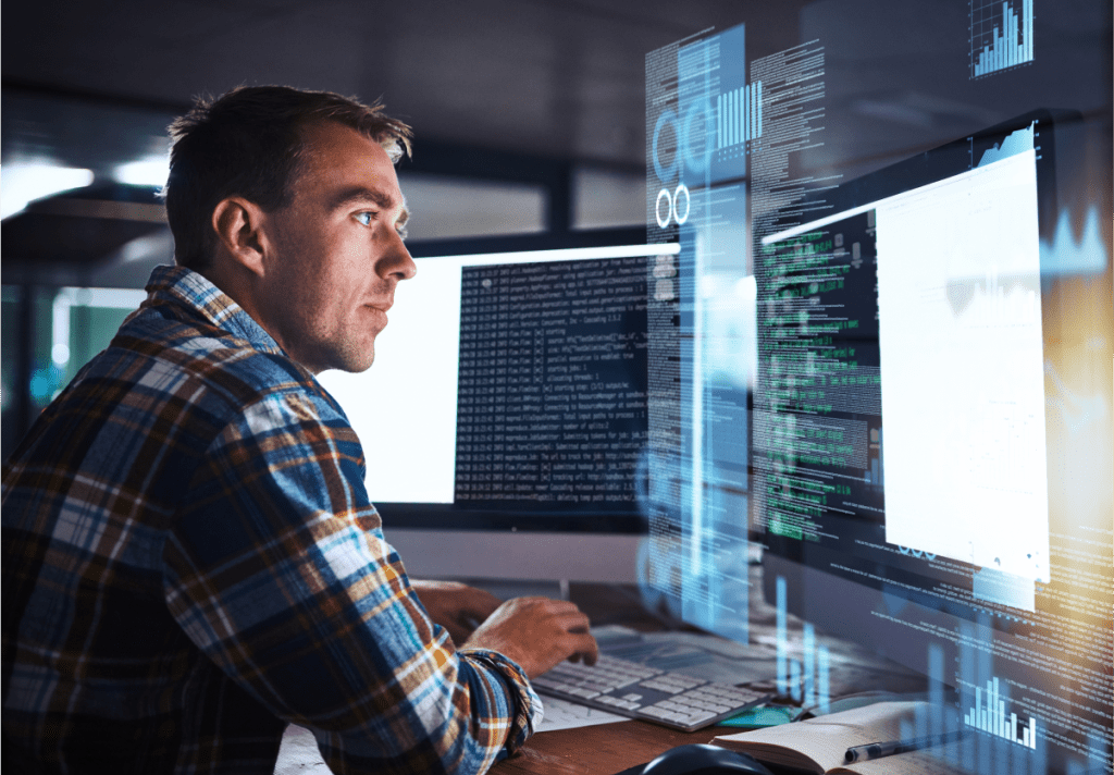 Un homme travaillant sur du code d'ingénierie systèmes